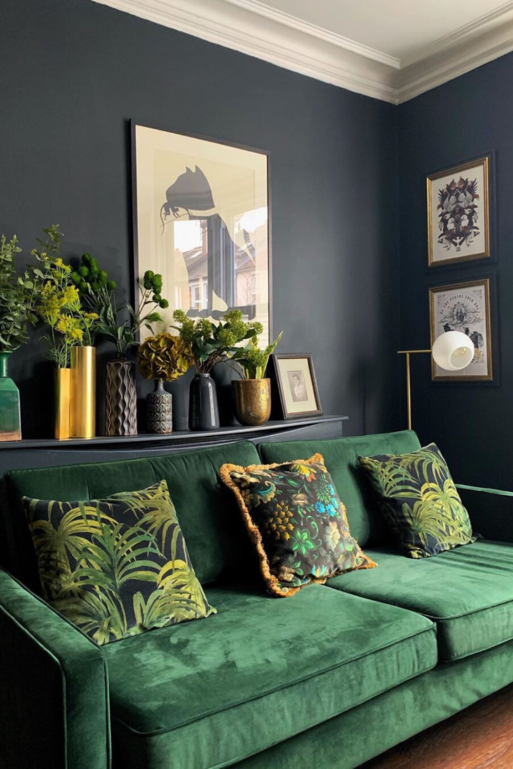 A Living Room With Green Velvet Couches And Potted Plants On The Shelf ... for