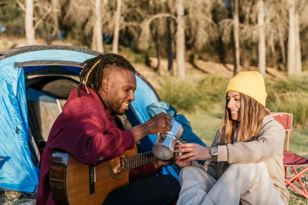 Premium Photo | Multiracial Couple In Camping Tent Man With Guitar ... with Beyond the Brew Exploring the Full Potential of the Tent Bed Espresso W/Blue Tent Kit
